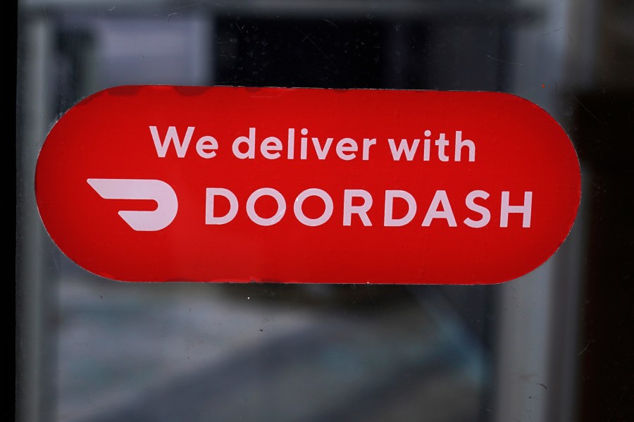 FILE - A DoorDash sign is posted on the door of a Dunkin' Donuts franchise, Feb. 27, 2023, in Methuen, Mass. (AP Photo/Charles Krupa, File)