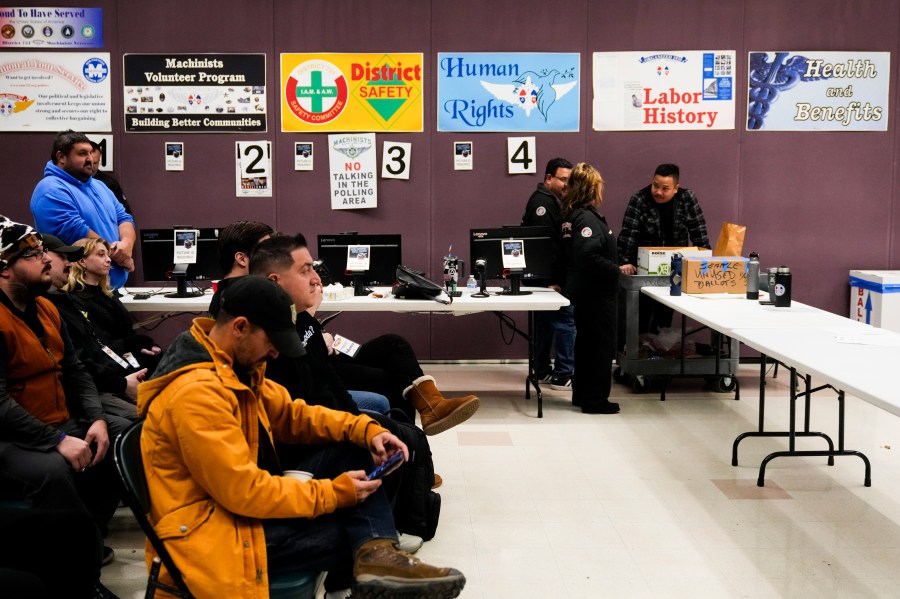 Observers watch as volunteers tally votes on a new contract offer from Boeing, Monday, Nov. 4, 2024, at IAM District 751 Union Hall in Seattle. (AP Photo/Lindsey Wasson)