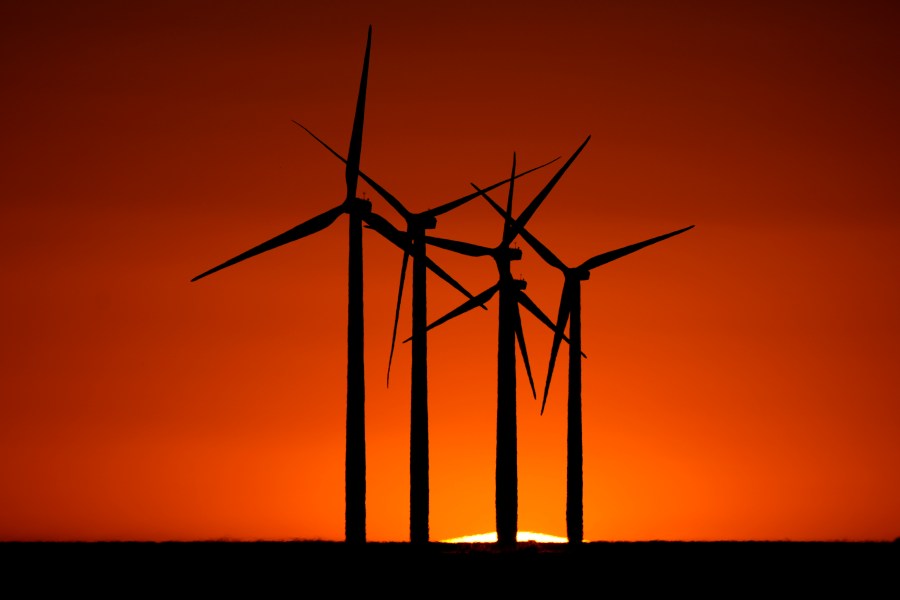 Wind turbines are silhouetted against the setting sun at the Spearville Wind Farm, Sunday, Sept. 29, 2024, near Spearville, Kan. (AP Photo/Charlie Riedel)