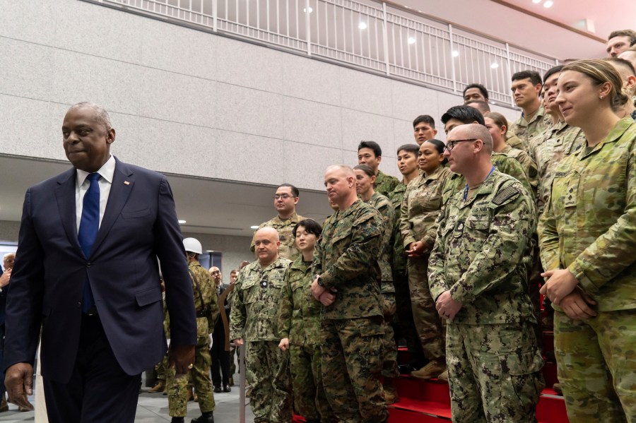 U.S. Secretary of Defense Lloyd Austin, left, leaves after addressing military personnel from Japan, the United States, and Australia during a visit to Camp Asaka, a Japan Ground Self-Defense Force base, on the outskirts of Tokyo Wednesday, Dec. 11, 2024. (Tomohiro Ohsumi/Pool Photo via AP)