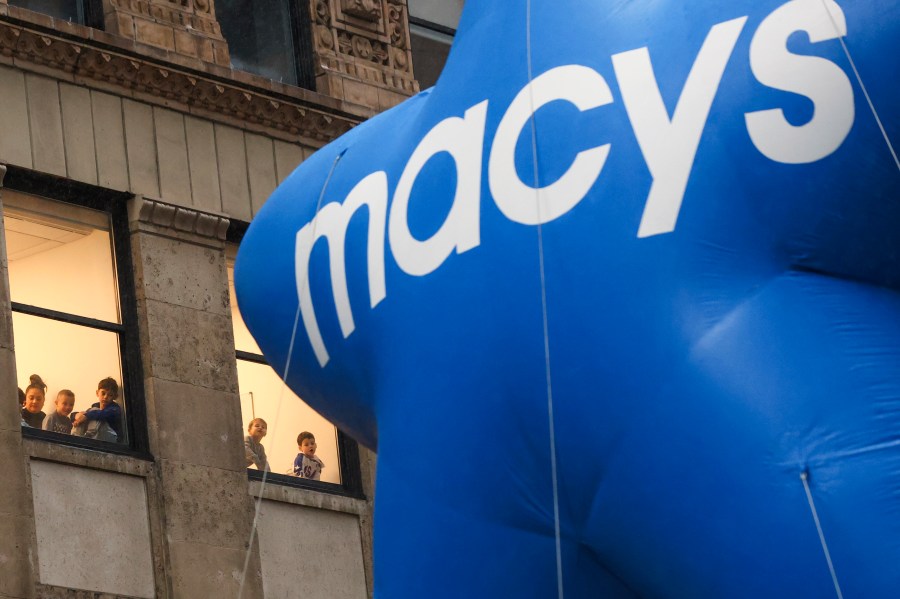 FILE - People watch from inside as a Macy's float passes during the Macy's Thanksgiving Day parade, Nov. 28, 2024, in New York. (AP Photo/Heather Khalifa, File)